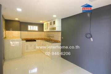 Modern kitchen interior with tiled backsplash and light cabinets