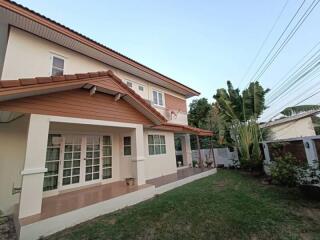 Two-story house exterior with a garden