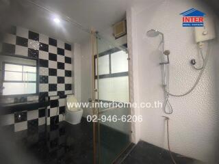 Modern bathroom with glass shower and black-and-white checkered tiles