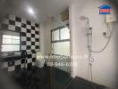 Modern bathroom with glass shower and black-and-white checkered tiles