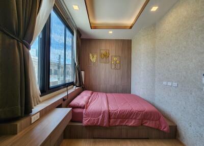 modern bedroom with wooden decor and large window