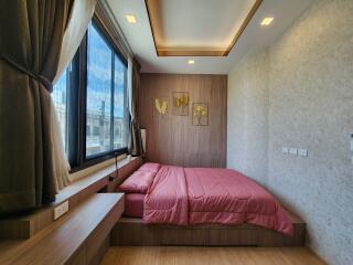 modern bedroom with wooden decor and large window