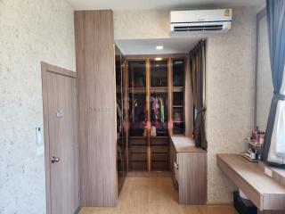 Spacious bedroom with wardrobe and vanity area