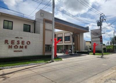 Entrance view of a modern residential building named RESEO HOME