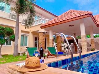 Outdoor view of a house with a pool and patio area