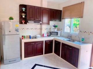 Modern kitchen with wooden cabinets and appliances