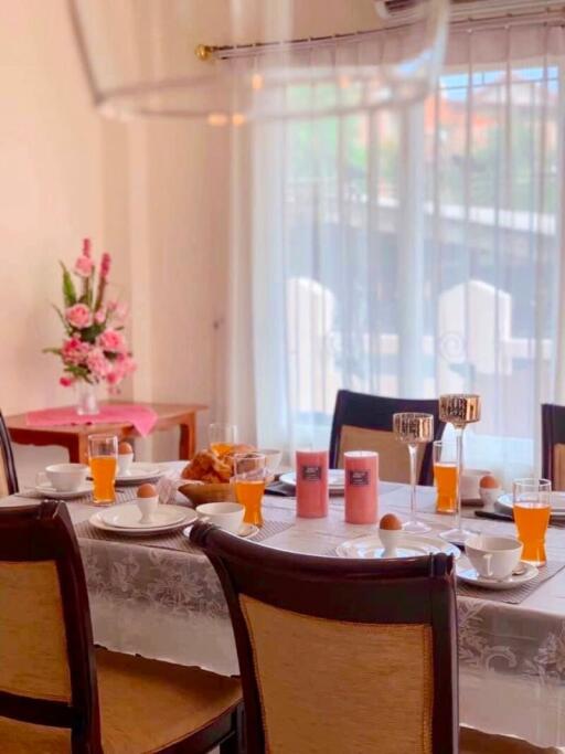 Dining room with table set for breakfast