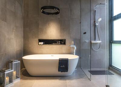 Modern bathroom with a freestanding bathtub and a glass shower enclosure