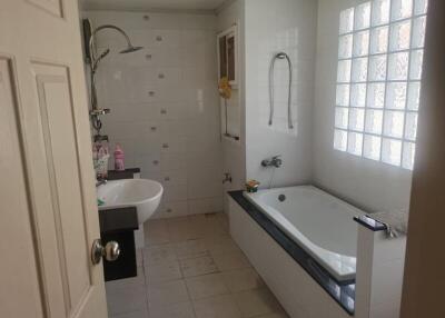 Modern bathroom with a bathtub, sink, and shower