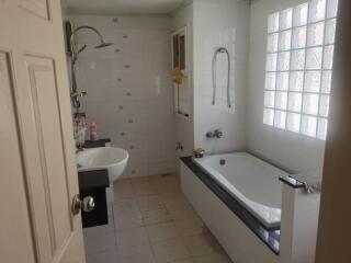 Modern bathroom with a bathtub, sink, and shower