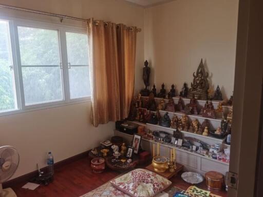 Bedroom with multiple Buddha statues