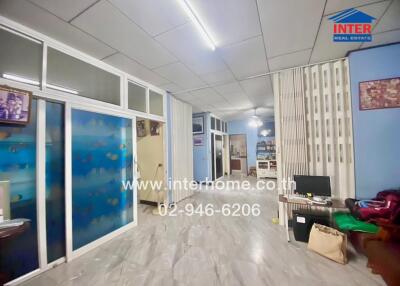 Spacious living area with glass partitions and decorative flooring