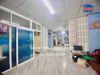 Spacious living area with glass partitions and decorative flooring