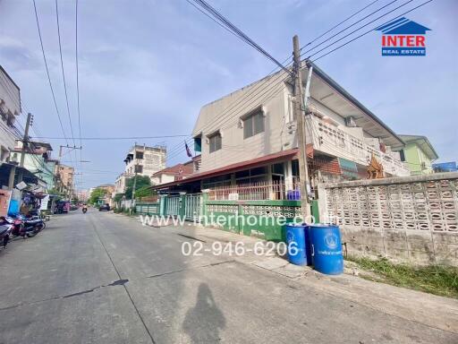 Street view of a residential area with various buildings