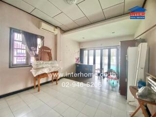 Living room with tiled floor, air conditioner, and large windows