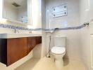 Modern bathroom with a toilet, wooden vanity, and mirror