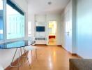 Bright living space with dining area and wall-mounted TV