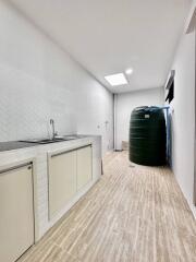 Spacious utility room with sink and water storage tank