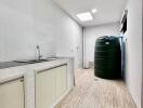 Spacious utility room with sink and water storage tank