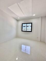 Minimalist bedroom with window and tiled floor