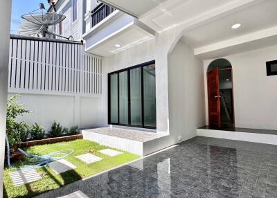 Outdoor patio area with tiled flooring and view of house