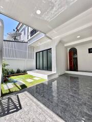 Outdoor patio area with tiled flooring and view of house