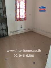 Empty room with tiled floor and visible wall damage