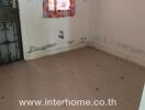 Empty room with tiled floor and visible wall damage