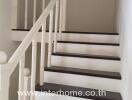 Indoor staircase with wooden railing