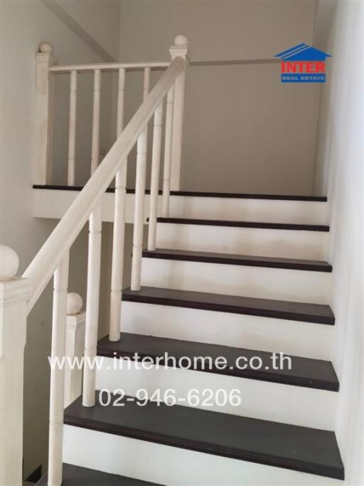 Indoor staircase with wooden railing