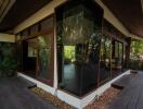 Exterior view of modern house with large glass windows and wooden deck