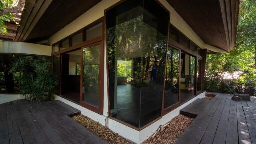 Exterior view of modern house with large glass windows and wooden deck