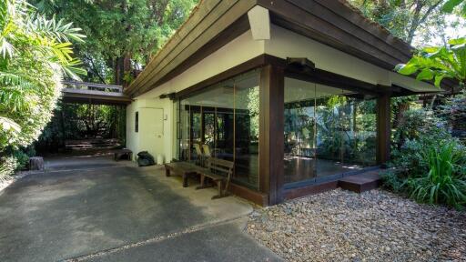 Modern house exterior with large glass windows and natural surroundings