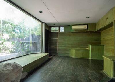 Spacious living room with wooden flooring and large window