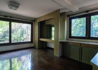 Spacious room with large windows and built-in cabinetry