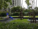 Residential outdoor playground area with slides and greenery