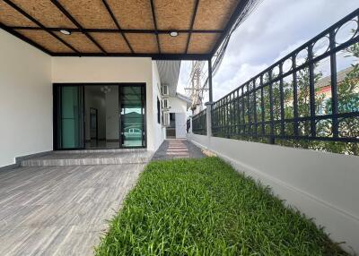 Outdoor patio with small garden area and large sliding glass doors