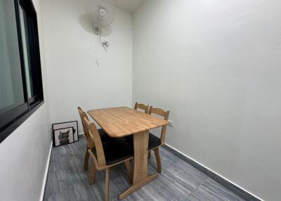 Small dining area with a wooden table and four chairs