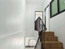 Modern staircase with wooden steps and black railings