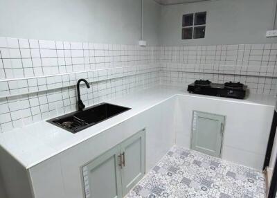 Modern kitchen with tiled backsplash and patterned floor