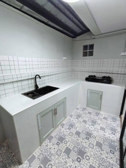 Modern kitchen with tiled backsplash and patterned floor