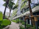 Modern apartment building exterior with lush landscaping