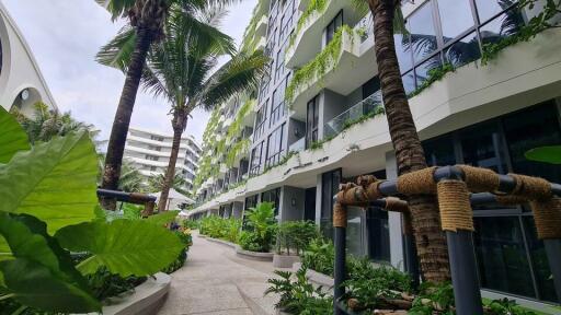 Modern apartment building exterior with lush landscaping