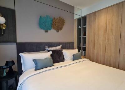 Modern bedroom with a double bed, stylish decor and wooden wardrobe