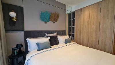 Modern bedroom with a double bed, stylish decor and wooden wardrobe