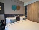 Modern bedroom with a double bed, stylish decor and wooden wardrobe