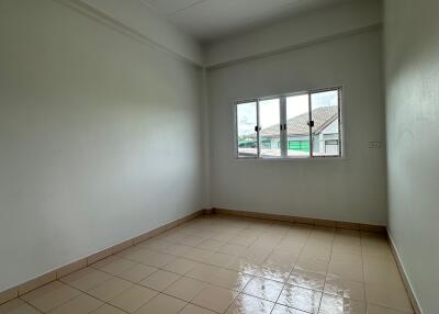 Empty bedroom interior with window and tiled floor
