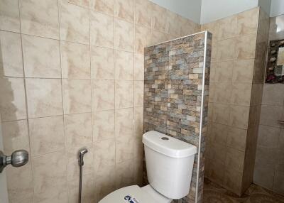 Bathroom with tiled walls and a toilet