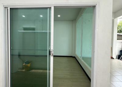 Room with sliding glass door and tiled floor