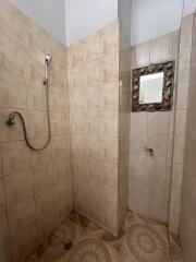 Bathroom with tiled walls and shower area